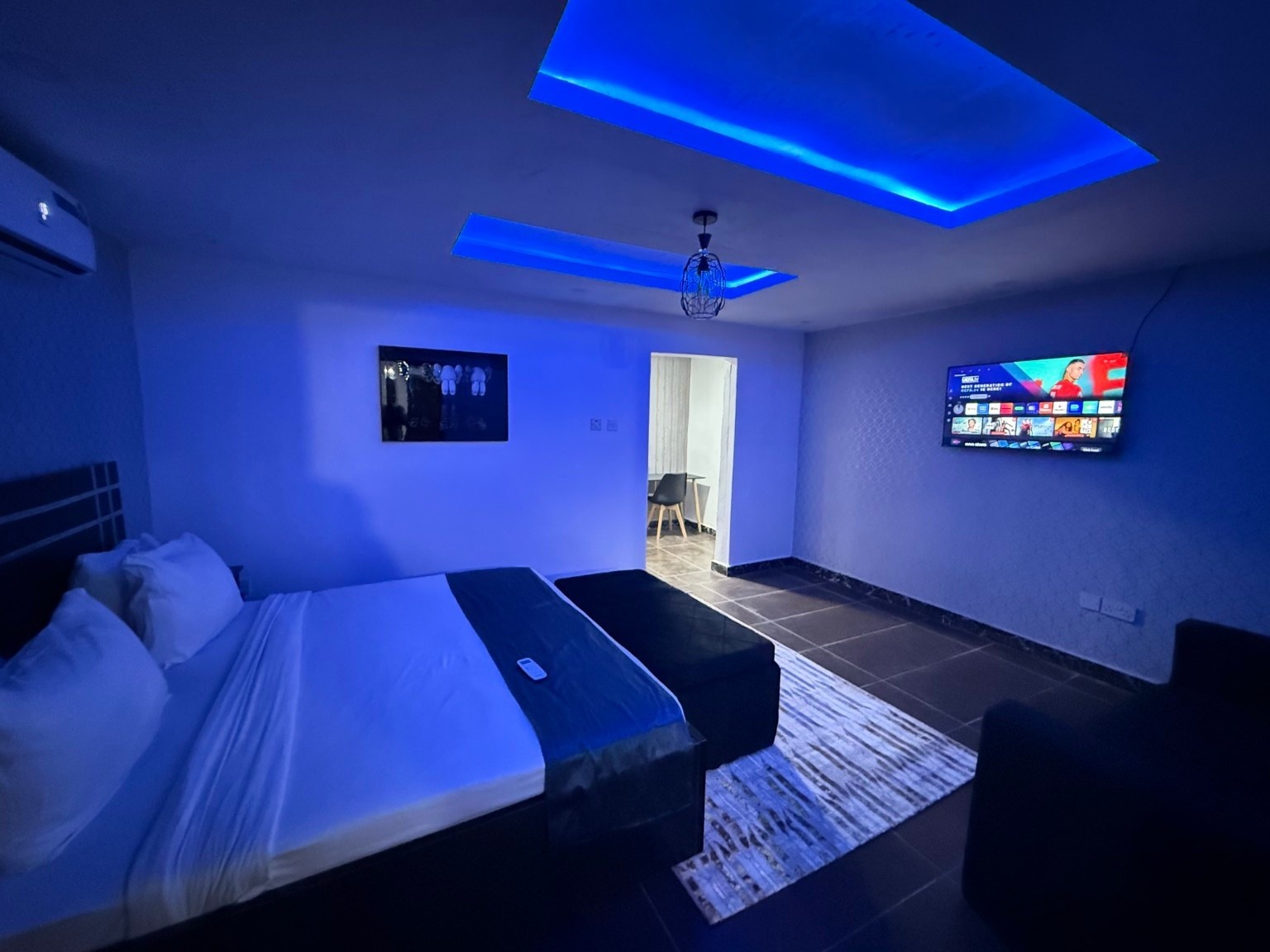 Guest room at Ikeja Central Hotel with blue ceiling lighting